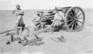 IWM Q 24267: A British 18-pounder Field Gun firing from an open position in the flat desert landscape of lower Mesopotamia